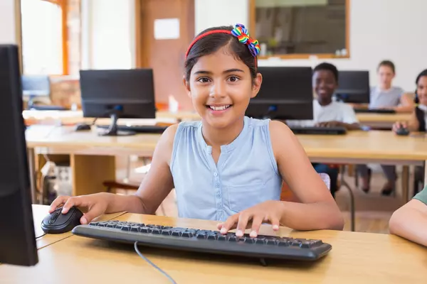 girl learning python programming at computer